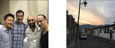 A group of men are posing for a picture in front of a building.