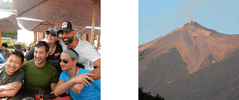 A group of people are posing in front of a volcano.