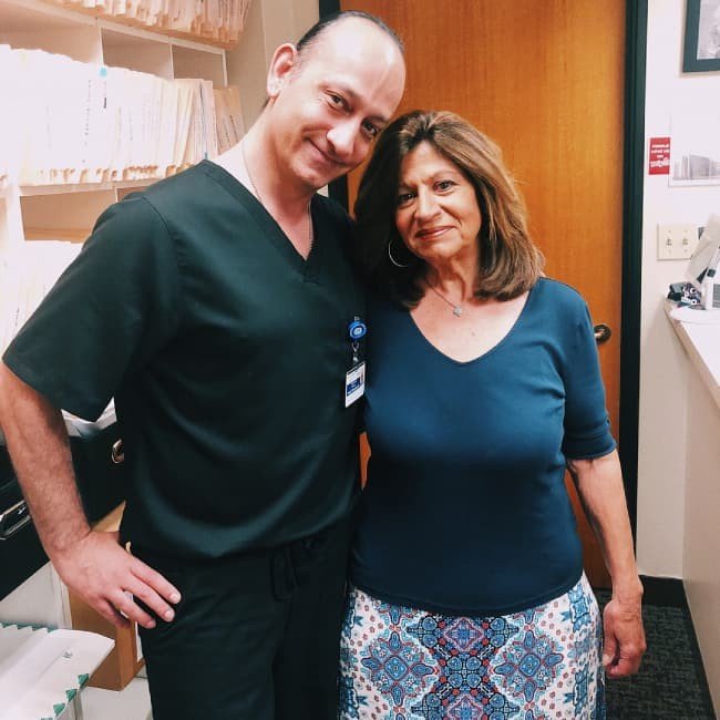 A man and a woman standing next to each other in a dental office.