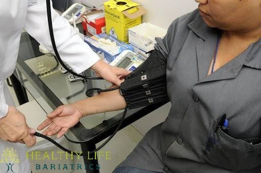 A doctor is checking a patient's blood pressure.