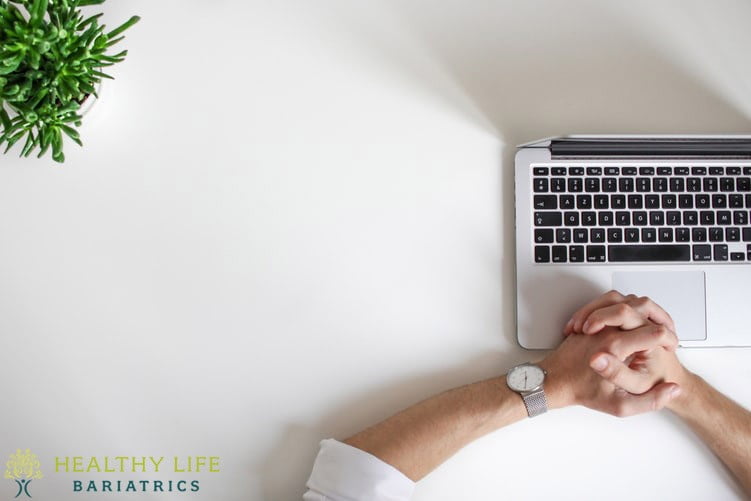 A person's hands on a laptop with the words healthy life biologics.