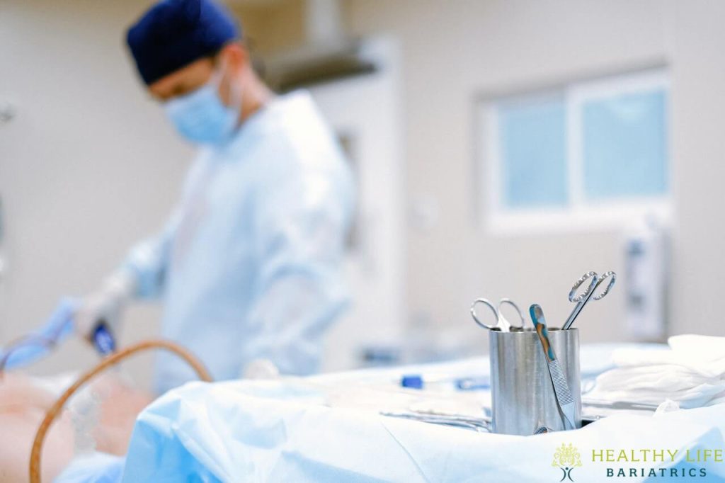 A surgeon is operating on a patient in an operating room.