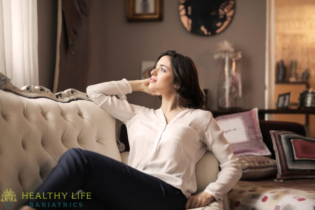 A woman sitting on a couch in a living room.