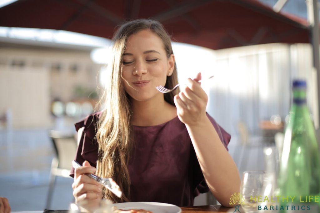 A woman eating at a restaurant.