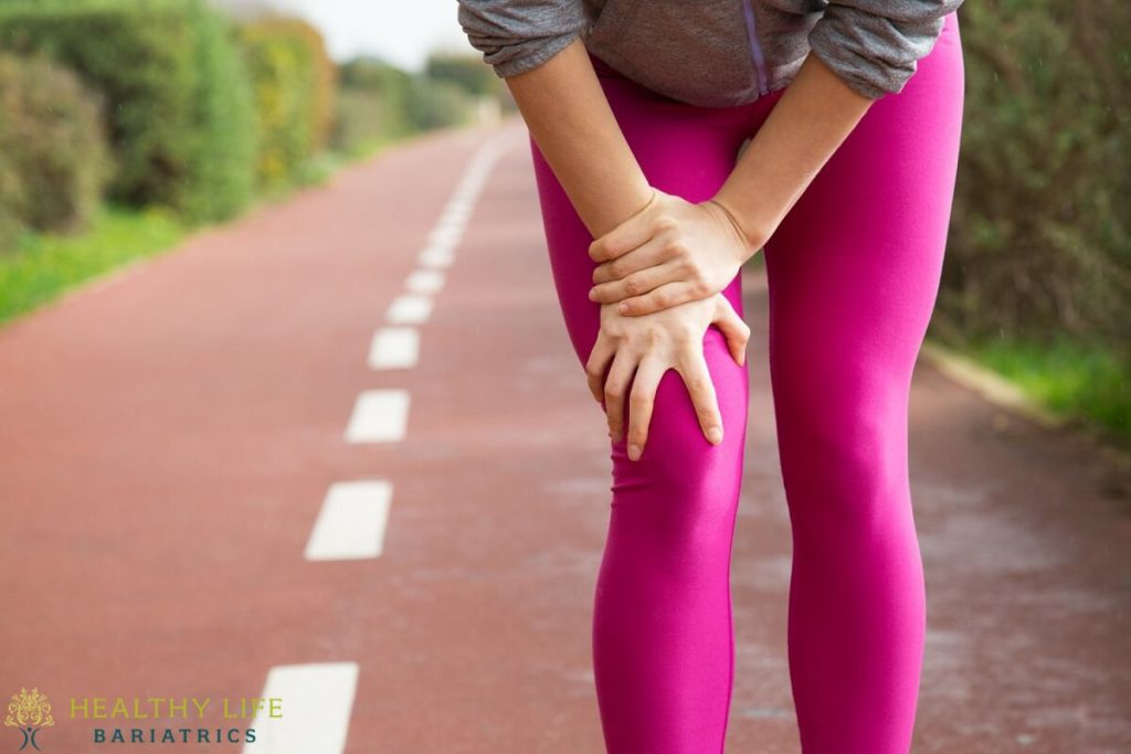 A woman with a knee injury on a road.