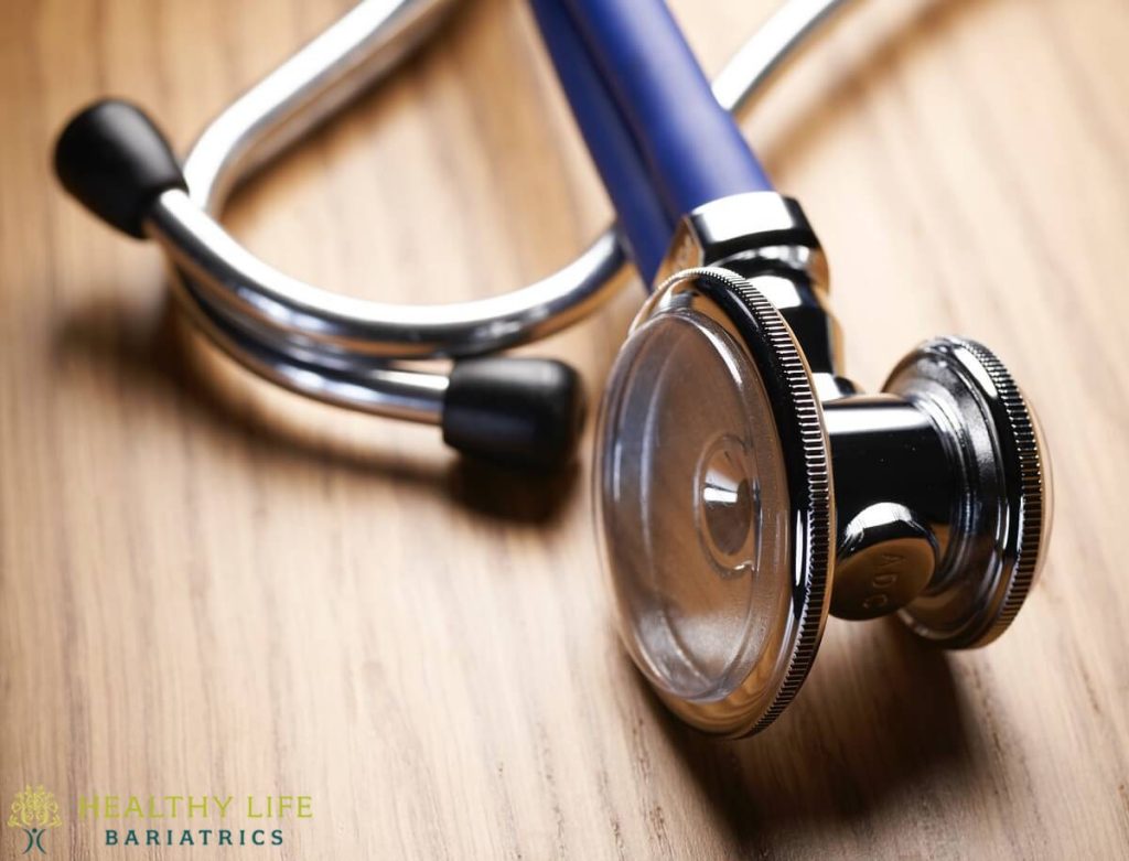 A stethoscope on a wooden table.