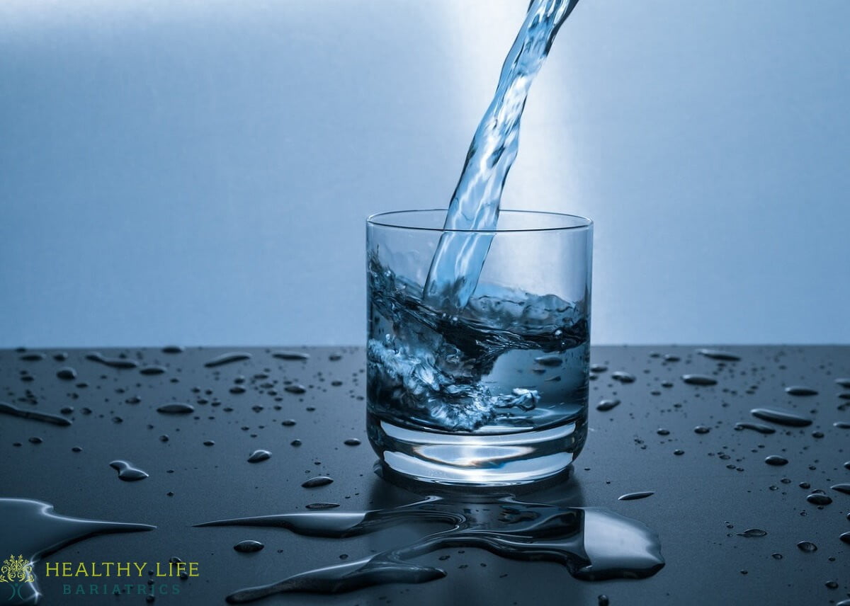 A glass of water being poured into a glass.