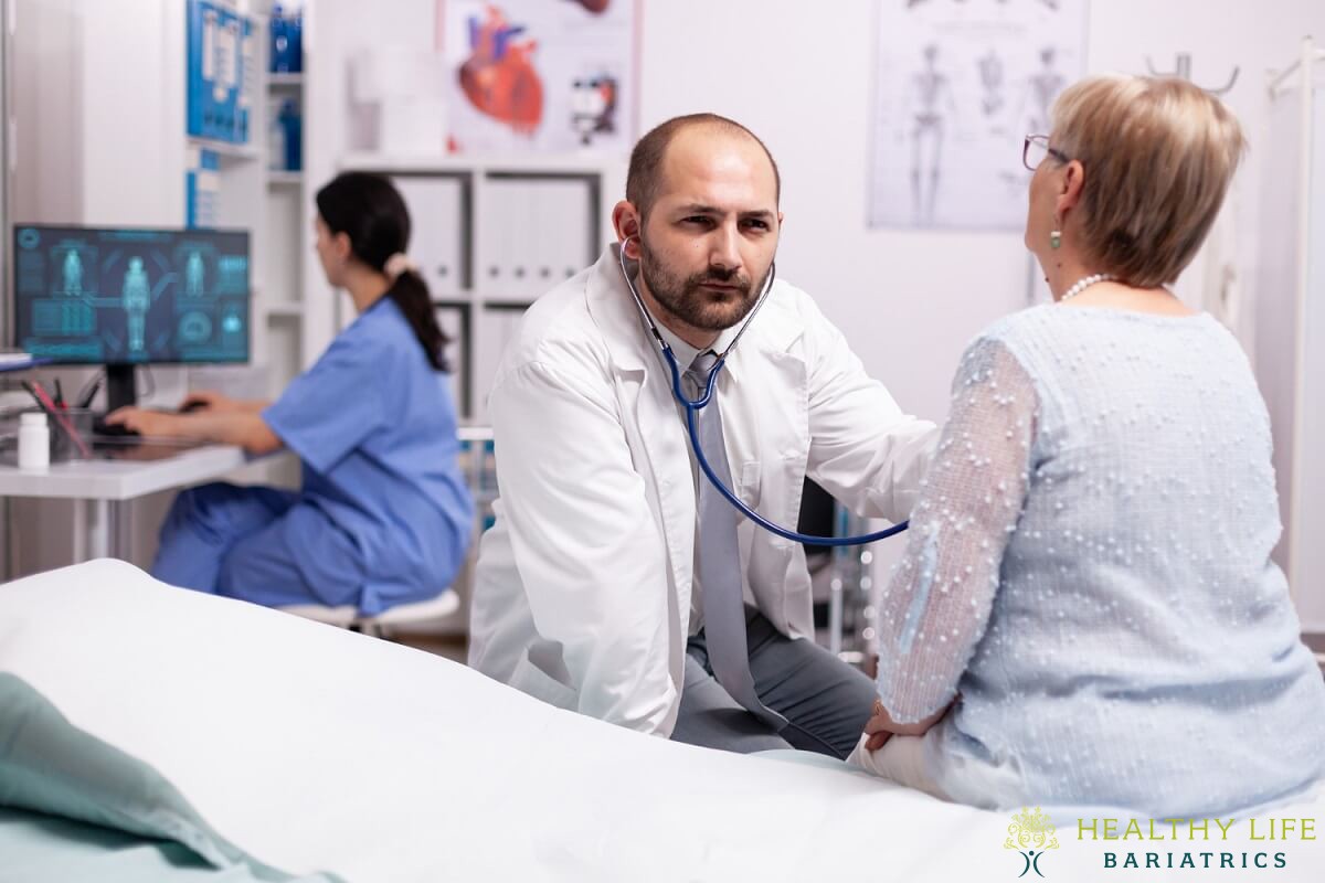 A doctor is talking to a patient in a hospital bed.