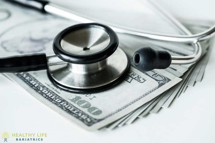 A stethoscope sits on top of a stack of money.