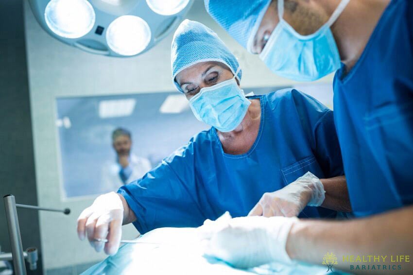 Two surgeons performing surgery in an operating room.