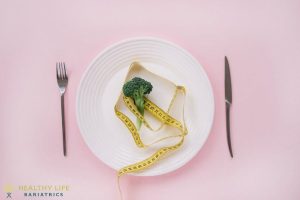 A plate with broccoli and measuring tape on it.