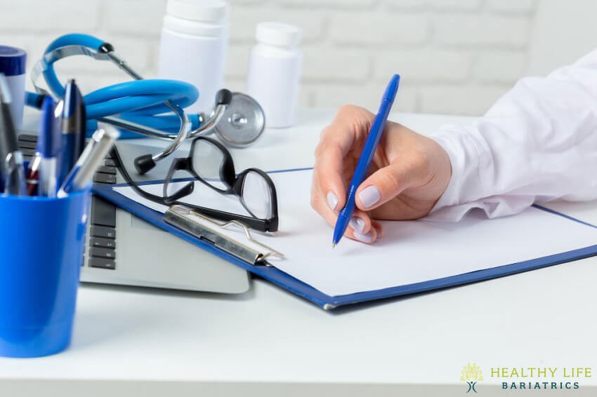 A doctor's office with a laptop and medical equipment.