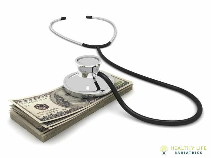 A stethoscope on top of a stack of money.