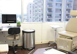 A medical office specializing in weight loss surgery equipped with a desk, chair, and computer.