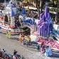 A float adorned with extravagant decorations floats down a bustling city street, catching everyone's attention.