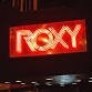 A Roxy neon sign, adorned with bright lights, proudly displays the word "Roxy" in a mesmerizing glow.