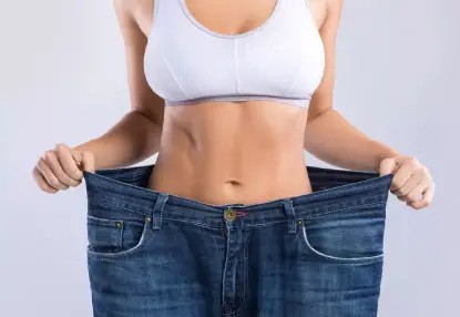 A woman wearing a garment and jeans in Los Angeles.